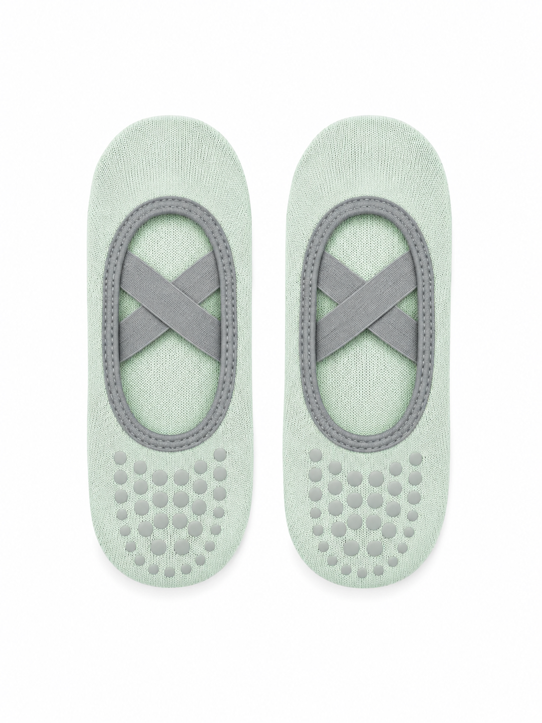 Pair of light green ballet slippers with gray straps on a white background