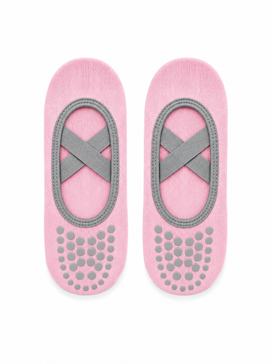 Pair of pink socks with gray grip patterns on a white background