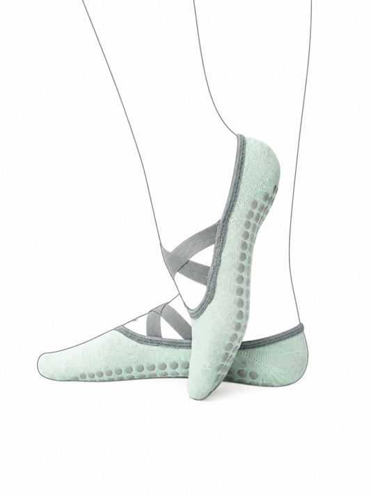 Light green socks with gray grips on a white background